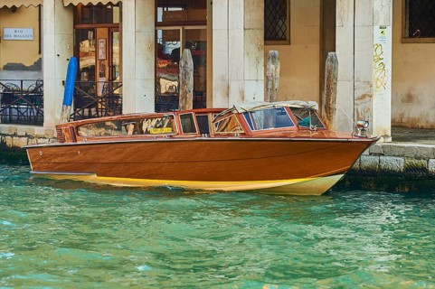 Boat lying in the water on a Waterway in Venice on a sunny day in winter, Italy