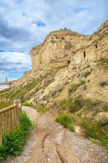 Pathway leading to the historical arguedas caves nestled in the rocky landscape of navarre, spain,