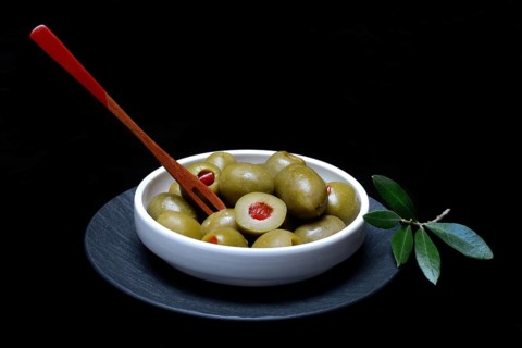 Green olives stuffed with pieces of paprika