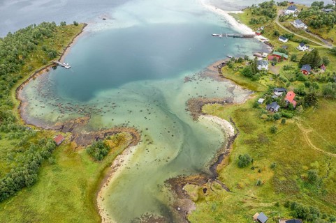 Aerial view of a bay at the Raftsund, single hut with boat, fjord between Lofoten and Vesteralen,