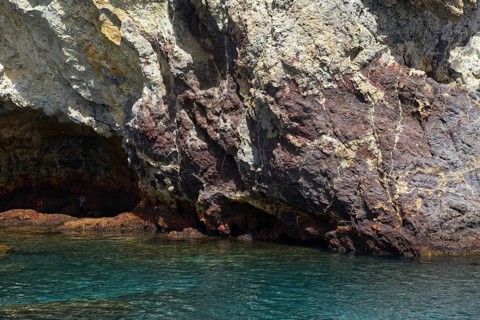 A rocky coast with impressive rocks and crystal clear water, Vulcano Lipari Islands, Sicily Italy
