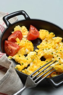 Scrambled eggs with tomatoes in a pan