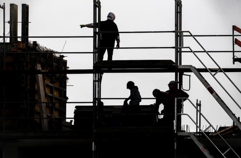 Construction site, scaffolding work on a large construction project, apartments and commercial