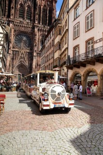Sightseeing tour with the tourist train in the historic centre of Strasbourg In the background the