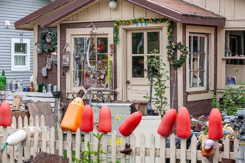 Art collection and crafts in front of a wooden house, shells, buoys, glass, Seward, Alaska, USA