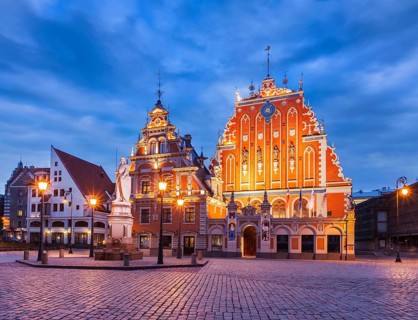 Riga Town Hall Square, House of the Blackheads and St. Roland Statue illuminated in the evening
