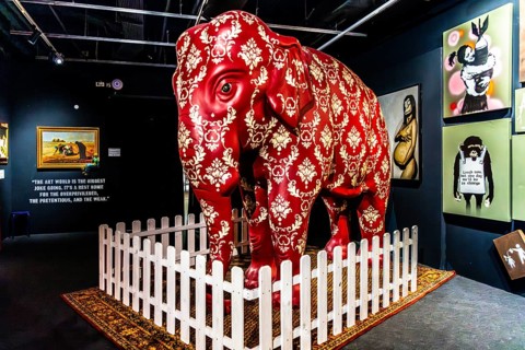 Banksy - Barely Legal exhibition with elephant in the room as a symbol of confrontation with
