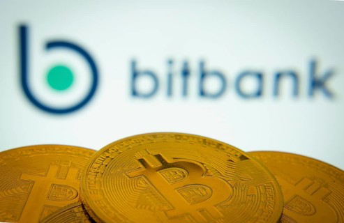 Dhaka, Bangladesh- 02 June 2025: Close-up of Bitcoin coins with the bitbank logo visible on a