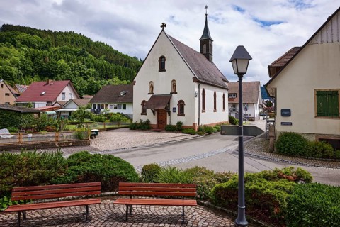 Chapel St. Josef, benches, lantern, hilly landscape with forest, crossing Bollenbacher Straße with