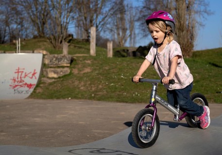 Little girl, 3 years old, blonde, riding a balance bike, crash helmet, playground, Stuttgart,