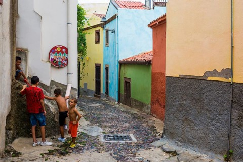 Children playing and colourful houses, Bosa, district of Oristano, Sardinia, Italy