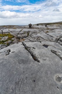 Bizarrely shaped limestone slabs, hiking trail along the coastline, limestone coast of the Burren,