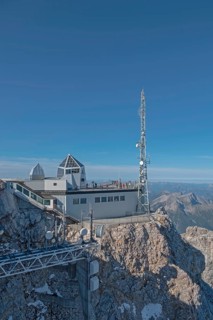 Mountain station and antenna on a rocky peak under a clear sky in the Alps, Zugspitze,