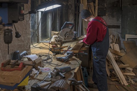 Young man working in his workshop in the evening, Mecklenburg-Vorpommern, Germany