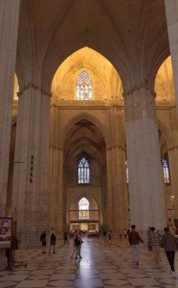 Extensive church interior with high vaults and illuminated windows, Seville, Andalusia, Spain