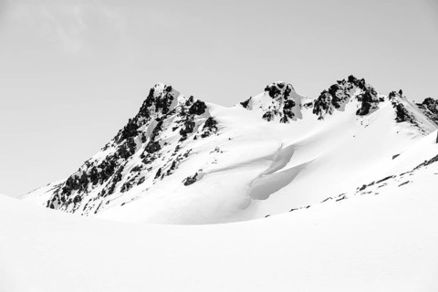 Minimalist winter landscape, white snow and dark mountains on the Scalettahorn, Graubünden,