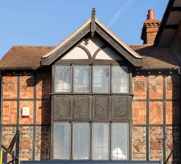 Facade of historic 1925 building heraldic symbols and signs, 105 High Street, Marlborough,
