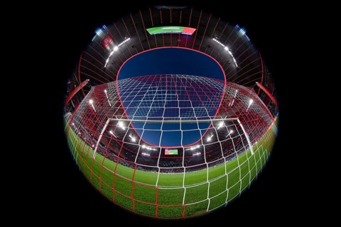 Overview, interior, floodlit match, behind-the-goal perspective, goal net, blue hour, fisheye shot,