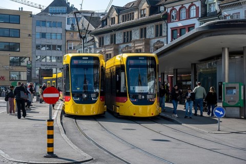 Two modern Stadler TINA trams on Barfüsserplatz in downtown Basel, operated by Baselland Transport