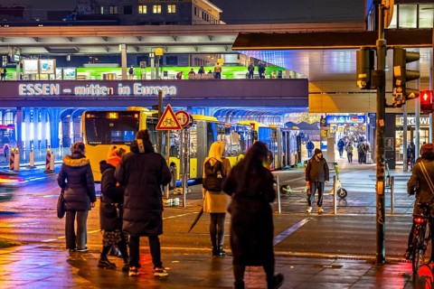 The main train station in Essen, blue illuminated underpass, bus station, am Europaplatz, train on