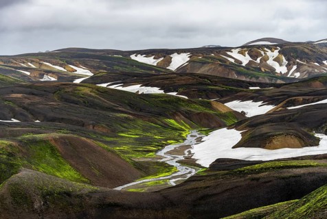Colourful volcanic landscape with hills and snow, volcanic hot springs, Laugavegur trekking trail,