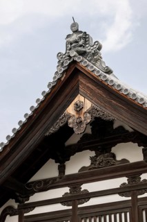Close-up of intricate wooden carvings and traditional roof design at Kinkaku-ji Temple in Kyoto,