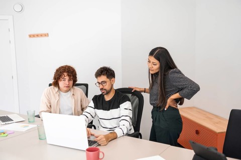 Diverse coworkers engage in collaborative work at a modern office A team of professionals discusses