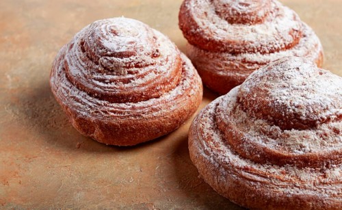 Bakery product, lemon twist, with white glaze, sweet bun, muffin, pastries, top view, no people
