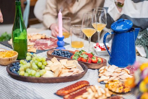 A vibrant charcuterie spread featuring grapes, strawberries, and blueberries, accompanied by