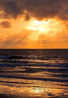 Outgoing tidal fringe in the mudflat landscape with setting sun, North Sea, Norderney Island, East