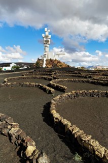 Stone walls in semicircles, viticulture in volcanic ash, Monumento al Campesino, monument to