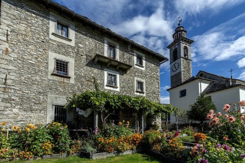 View of the village, typical Ticino stone houses in the mountain village of Rasa, Centovalli,