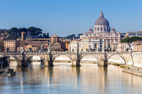Rome skyline with St Peter's Basilica in the Vatican Ponte Sant'Angelo bridge over the river Tiber