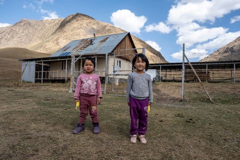 Two children in front of a farm, Issyk Kul province, Kyrgyzstan