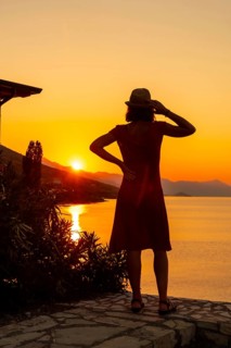 Silhouette of a woman at sunset at Shkoder lake in Shiroka municipality, summer vacation. Albania
