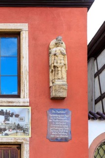 Historical figure of the pharmacist on the facade of the wall of the historic pharmacy on the