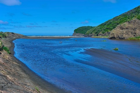 River landscape with hills and a clear sky, Bethells Beach, Te Henga, Auckland, New Zealand