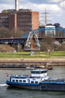 Cargo ships at the Mühlenweide, flagpole, on the Rhine, Ruhrort harbour, in the background the
