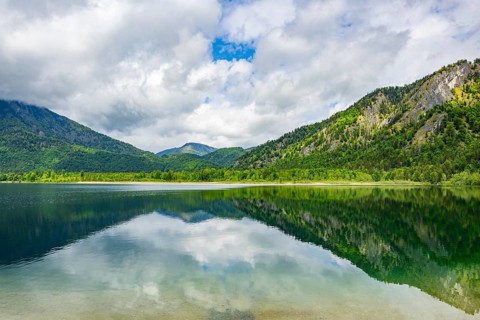 Landscape of Lake Offensee after rain when the sun comes through the clouds in spring,