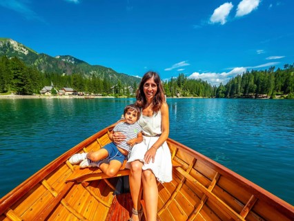 Tourists enjoying a relaxing boat trip on the beautiful lake braies, surrounded by the stunning