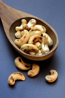 Cashew, roasted cashews in wooden ladle