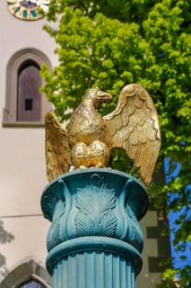 Fountain in front of the Protestant town church, green fountain with golden bird, detail, bird