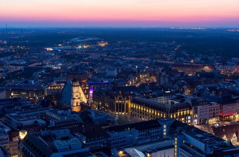 View of the city from the City Tower after sunset, St Thomas' Church, Red Bull Arena and Auwald