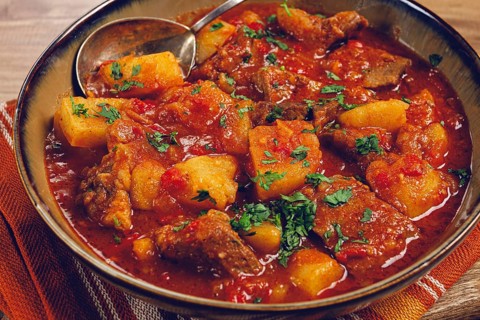 Potatoes with meat, stewed in tomato sauce, with spices and herbs, homemade, no people