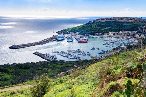 View from hill on harbour basin of Gozo Mgarr Harbour with small boats yachts yachts in front, in