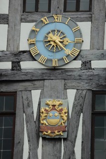 City coat of arms and golden clock at historic town hall, half-timbered house, detail, Michelstadt,