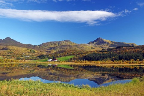 A clear day with mountains and a lake reflecting the surrounding autumn landscape, Vestvågøya,