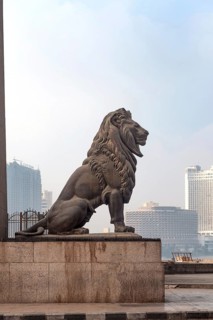 Cairo, Egypt. July 1st 2024 One of the famous bronze lions guarding Qasr El Nil Bridge over the