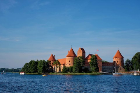Trakai Island Castle in lake Galve with boats and yachts in summer day with beautiful sky,