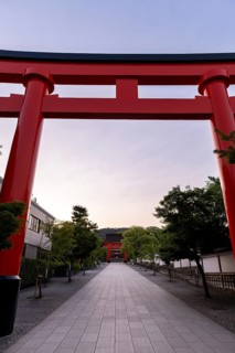 Serene morning view of the iconic Fushimi Inari-taisha shrine in Kyoto. The vibrant red torii gate